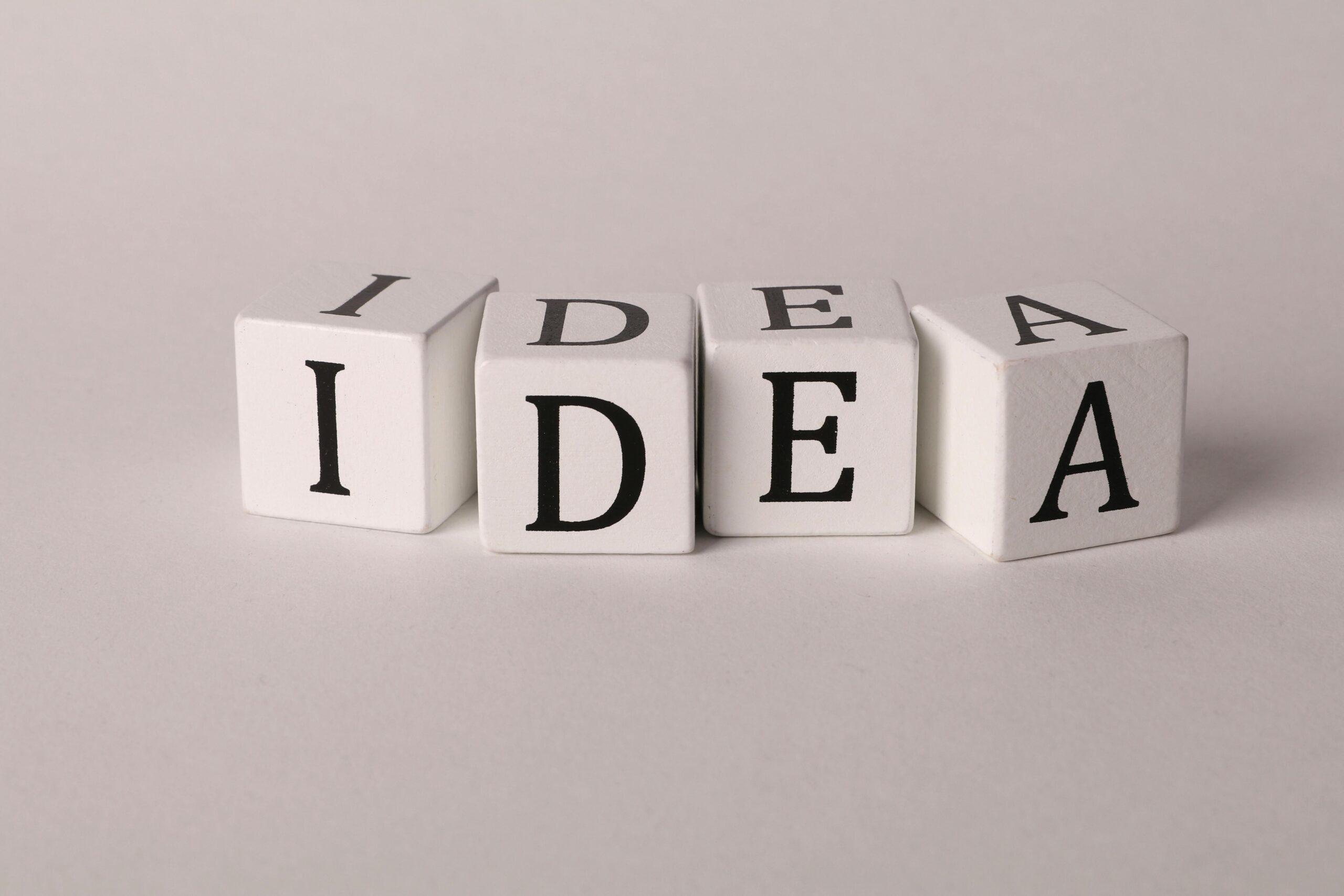 White blocks with letters spelling 'IDEA' representing creativity and innovation.